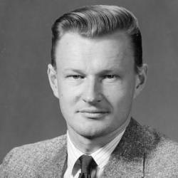 A person in a suit and tie Description automatically generated